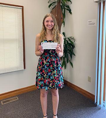 Allison Weaver with her first-prize check for the C. Henry Smith Peace Oration Contest