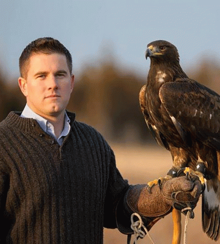 Falconer Nate Mathews with a golden eagle