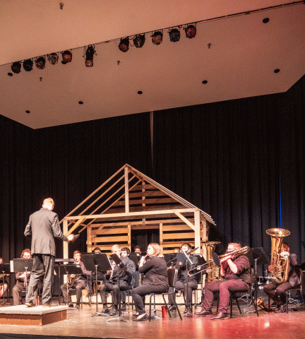 Joel Boettger leads the Wind Ensemble in February 2022