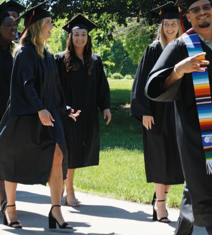 Graduating seniors make the walk around the Green to Mem Hall on May 15 for commencement.