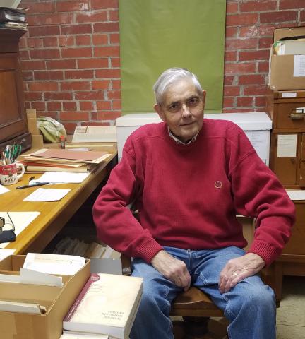 Keith Sprunger at his desk in the Mennonite Library & Archives