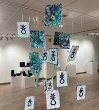 "Keep still. Wait. This is the moment of no turning back," handing paper installation by Rachel Epp Buller