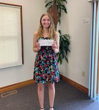 Allison Weaver with her first-prize check for the C. Henry Smith Peace Oration Contest